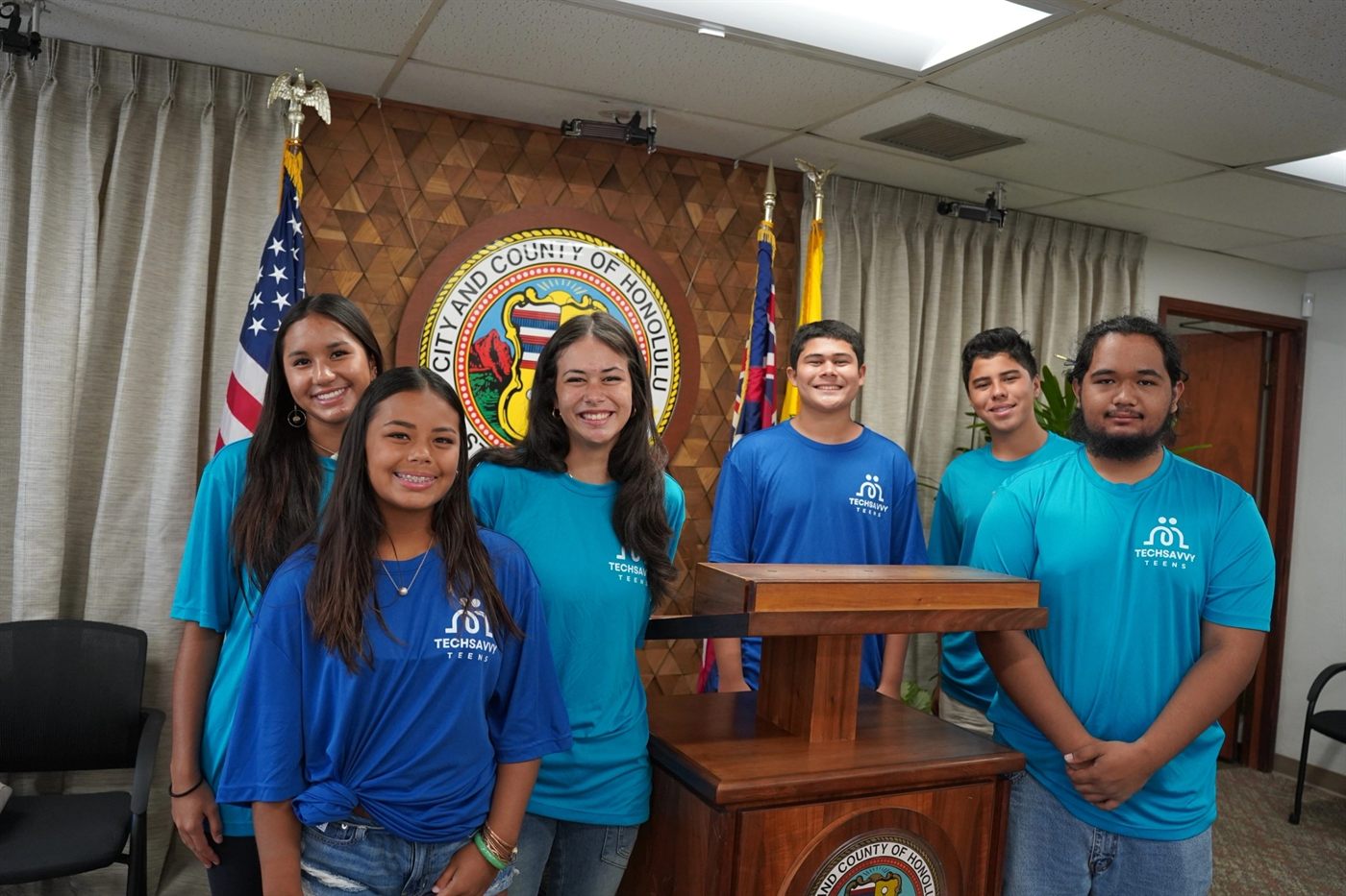 Six Tech Savvy Teens standing together at the City and County of Honolulu podium